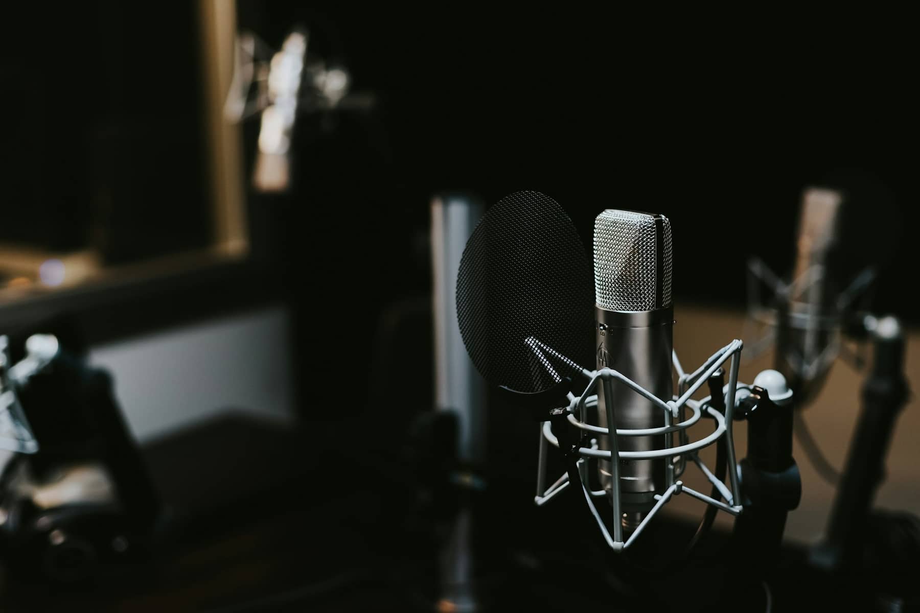 Studio microphone in a dark room representing AI voice technology